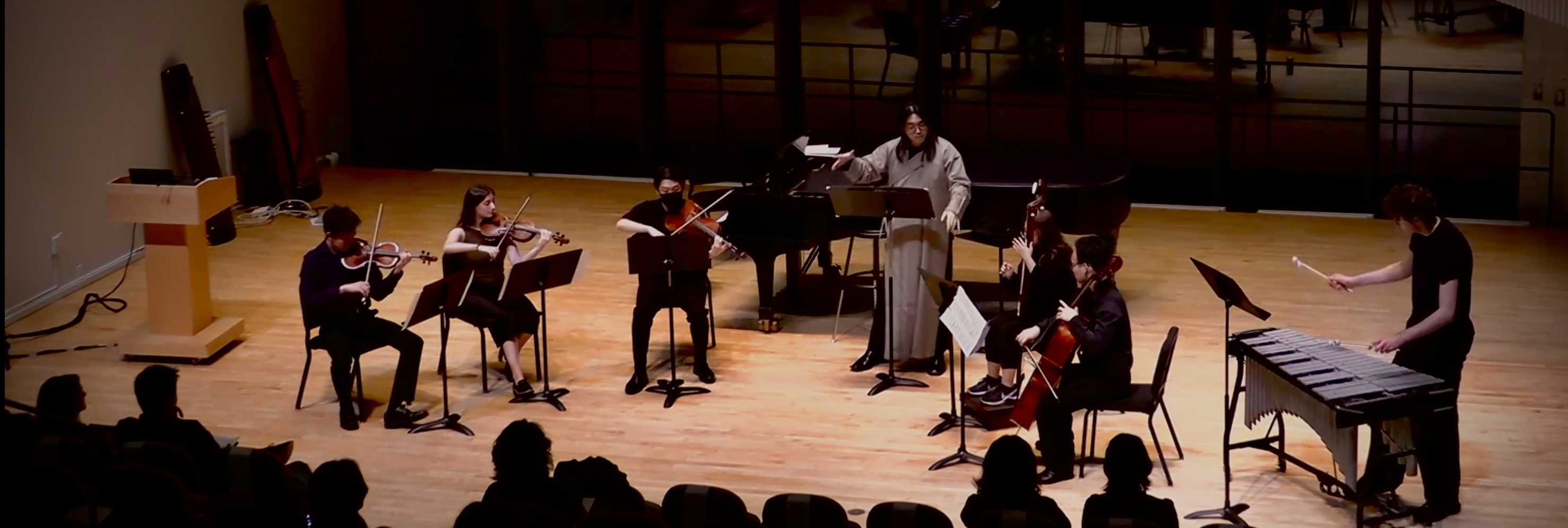 Musicians performing on stage during a concert.
